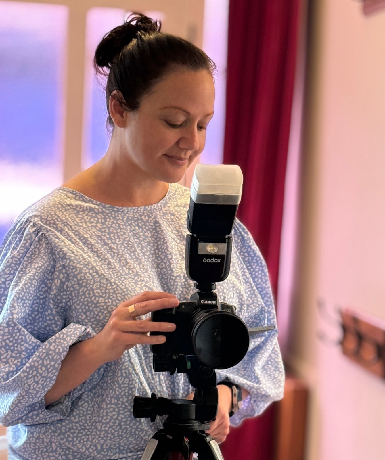 Helen Gwyther adjusting a flash-mounted camera on a tripod